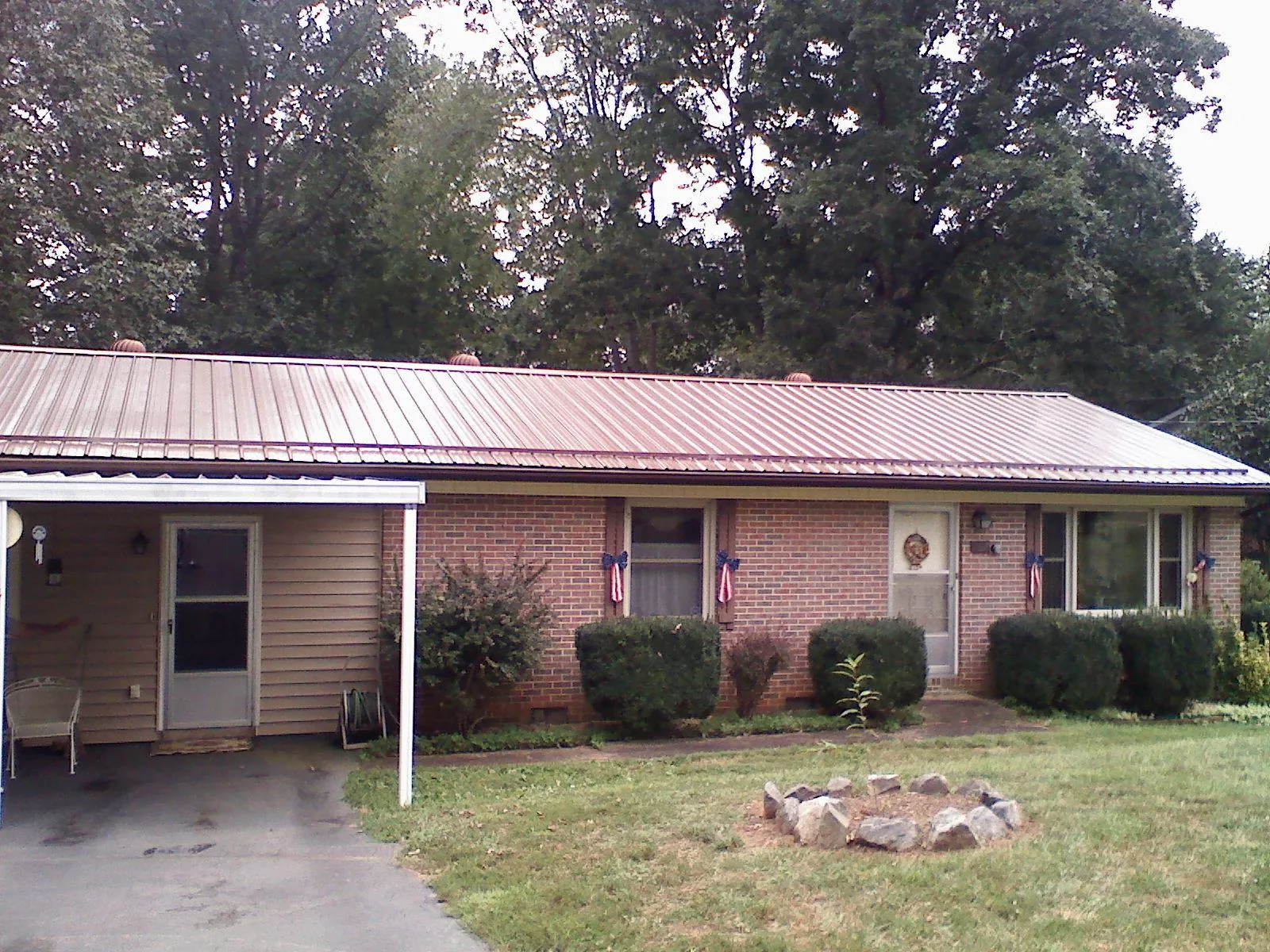 Bronze metal roof and carport on a brick ranch home — Roof Repair work by our crew in Sammamish